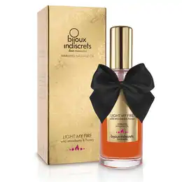 Разогревающее массажное масло light my fire с ароматом клубники и меда .