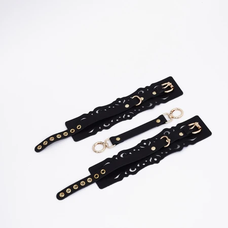 Okovi od crne kože sa uzorcima i zlatnim okovima